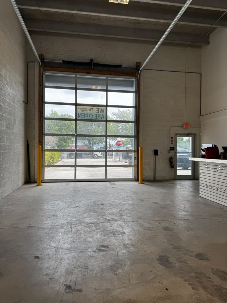 Interior showroom with full-glass overhead door at the front