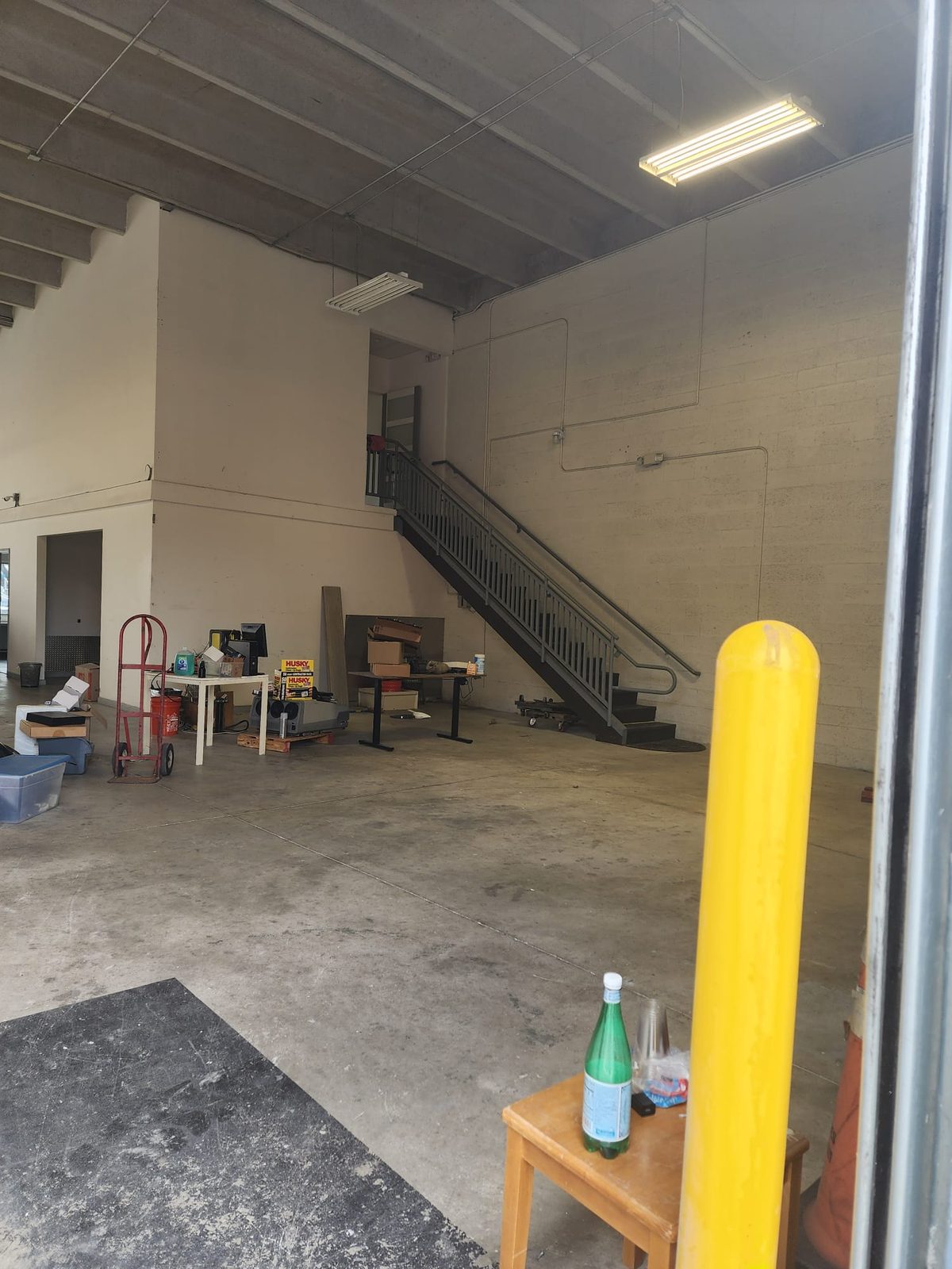 High-ceiling warehouse with interior stair to the mezzanine