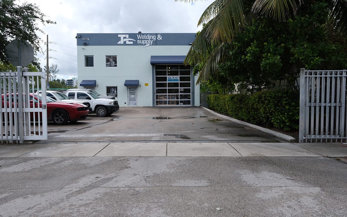 Freestanding industrial building with secure gated yard, drive-in door and private parking at 10810 NW 22 St, Doral FL 33172
